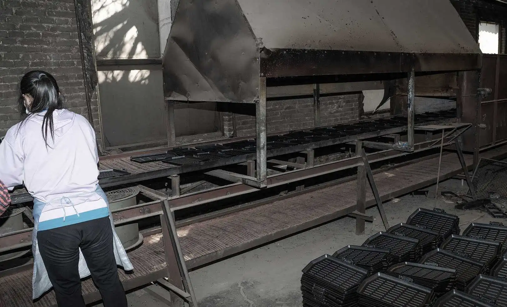 Cast iron cookware undergoing high temperature seasoning baking in the factory