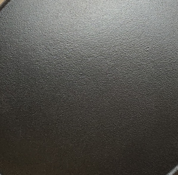 Close-up of a seasoned cast iron cooking surface from Meiloz